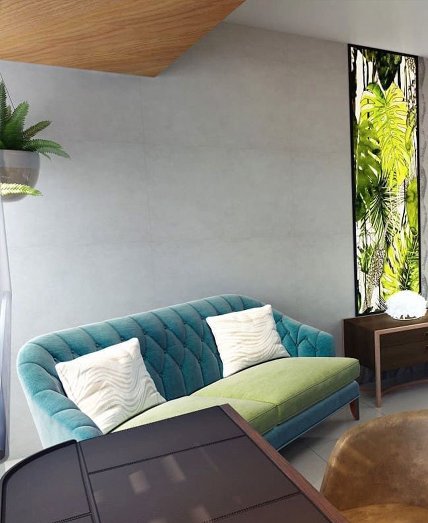 Una sala de estar con un sofá azul y un sofá verde.