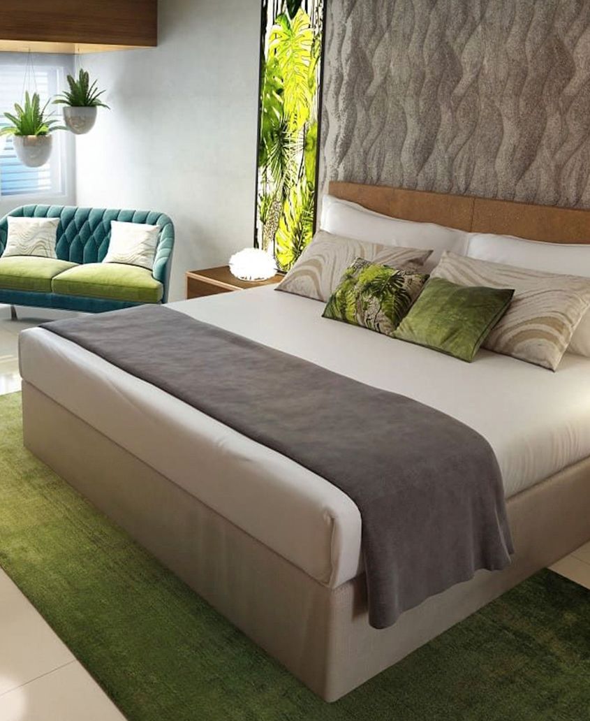 Un dormitorio con una cama grande y un sofá verde.