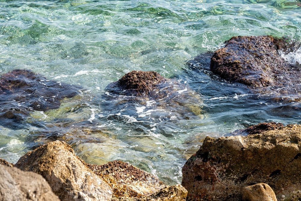 Hay rocas en el agua cerca de la orilla.