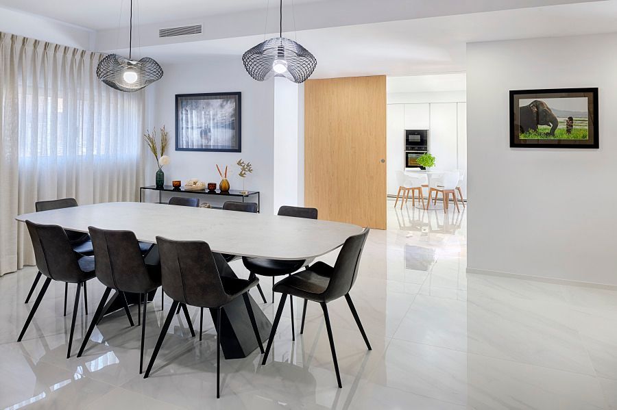 Un comedor con una mesa y sillas y un cuadro en la pared.