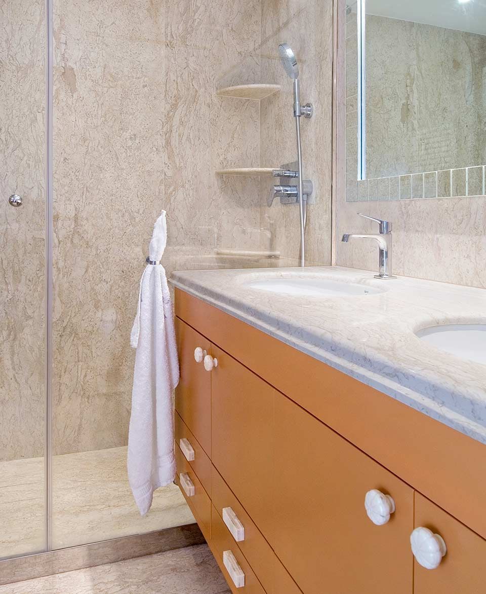 Un baño con lavabo, espejo y ducha a ras de suelo.