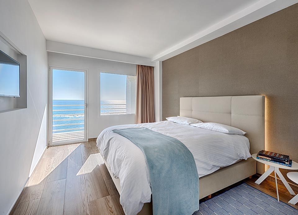 Un dormitorio con una cama grande y vista al mar.