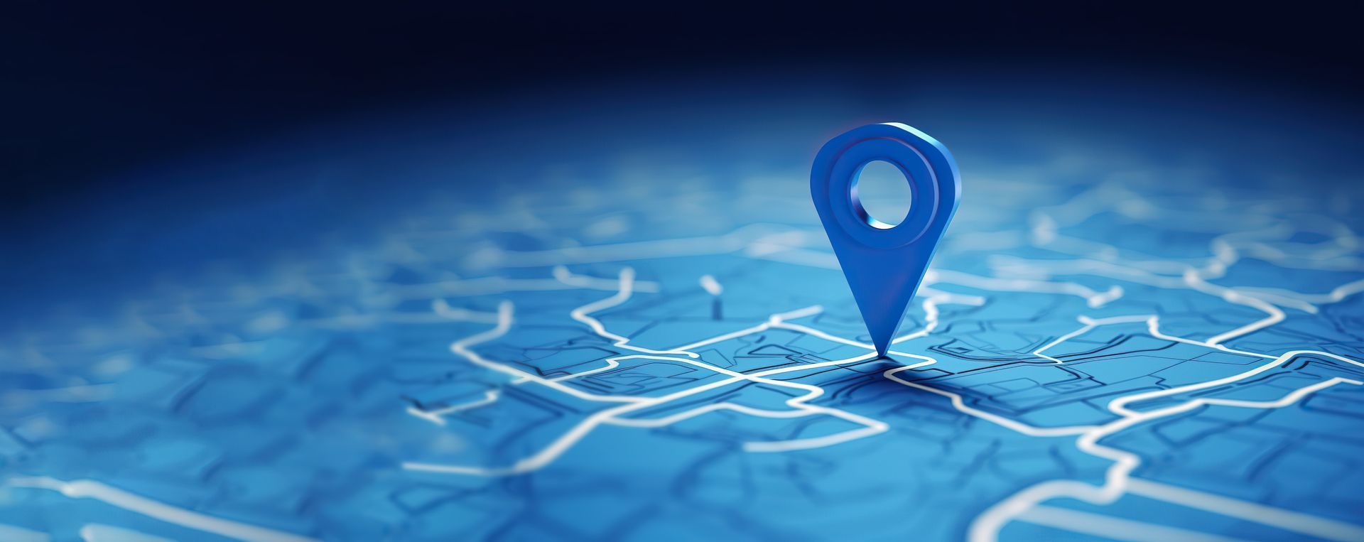 Épingle bleue sur une carte numérique avec routes blanches et fond bleu lumineux