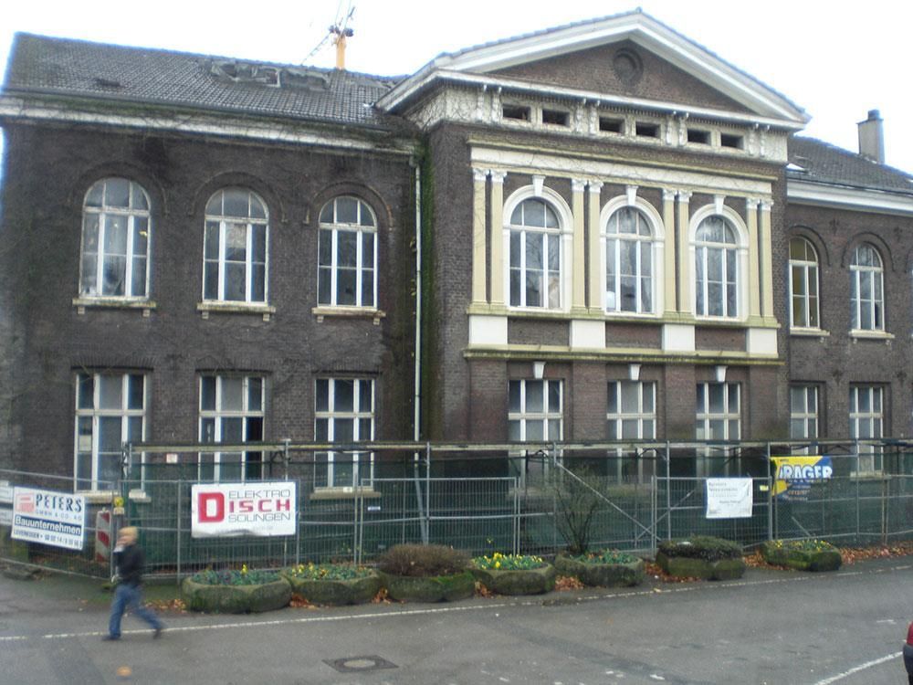 Ein Backsteingebäude mit einem Schild mit der Aufschrift „Disch“ darauf