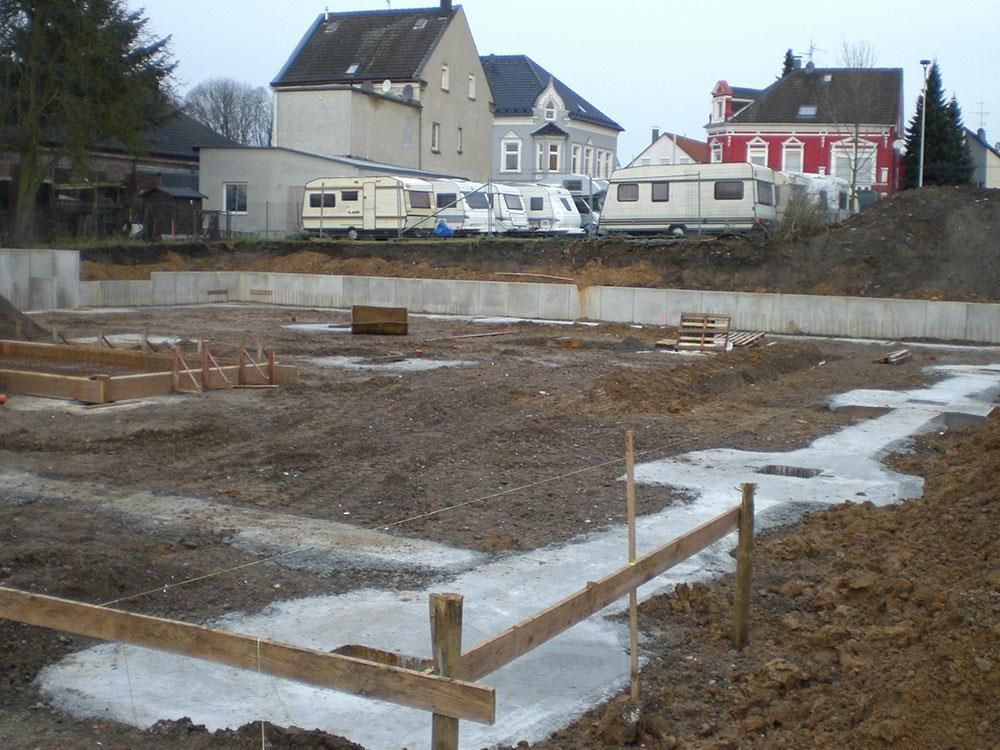 Eine Baustelle mit einem roten Gebäude im Hintergrund