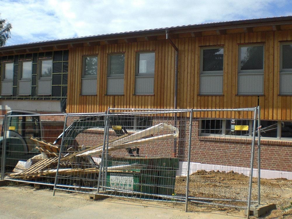 Ein im Bau befindliches Gebäude mit einem Zaun darum