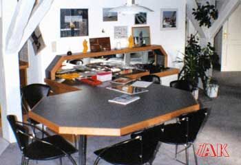 Ein Raum mit einem Tisch und Stühlen und dem Wort „Vak“ darauf
