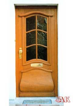 Eine Holztür mit einem Briefkasten an der Seite.