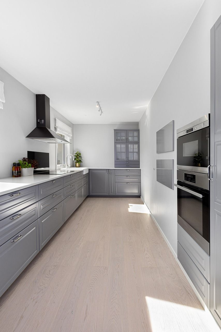 Cuisine moderne grise avec hotte noire.