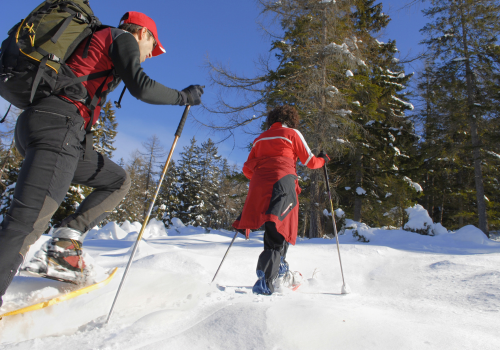 People snowshoeing throughout deep snow in the Black Hills