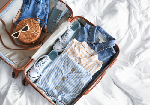 Packing with clothes and shoes in suitcase, preparing for trip to Deadwood SD