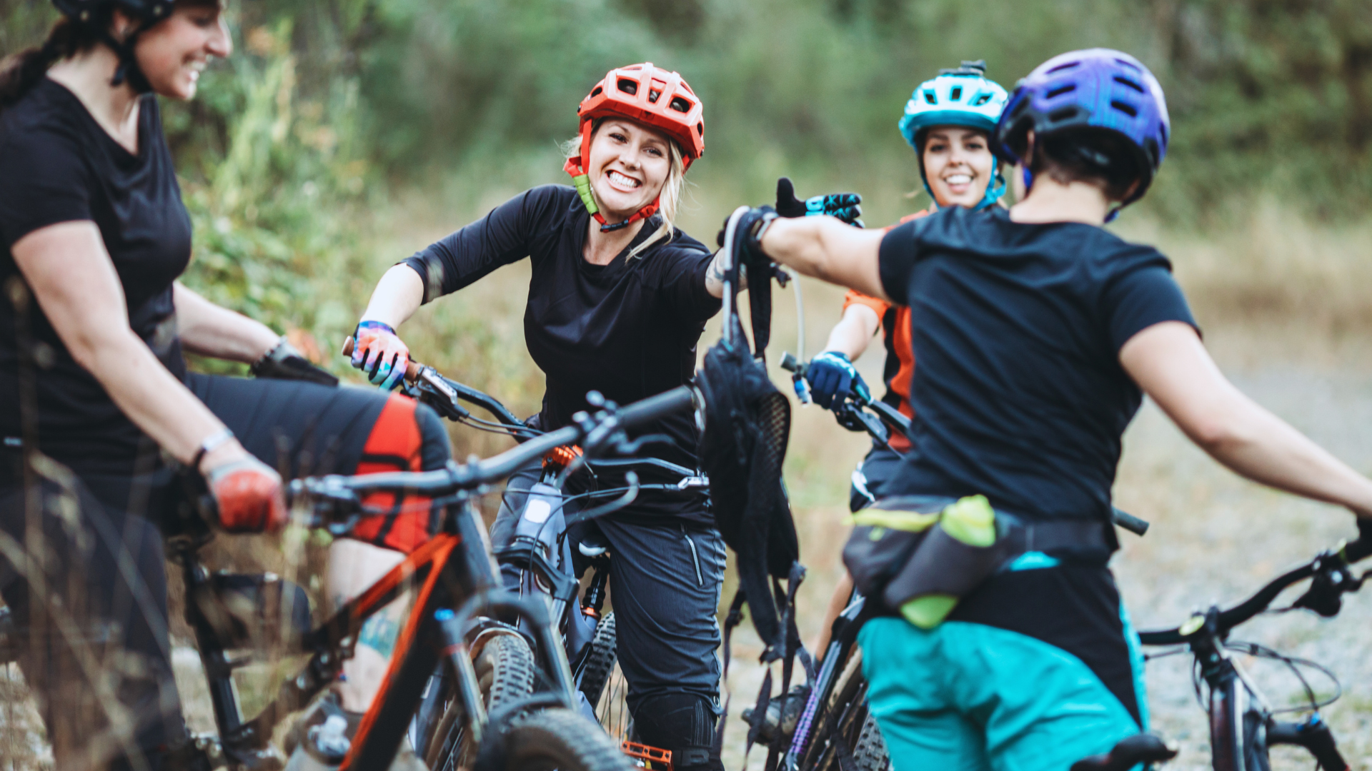 Group of people sitting on bike and talking to each other