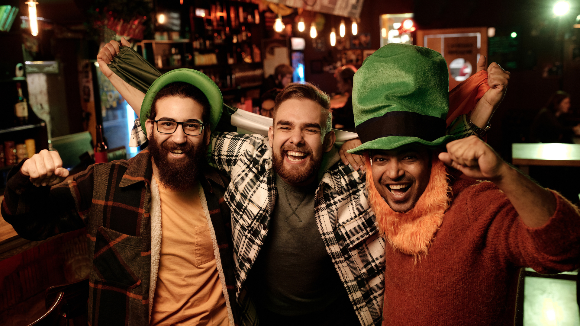 Group of guys together in green hats celebrating St. Patrick's Day