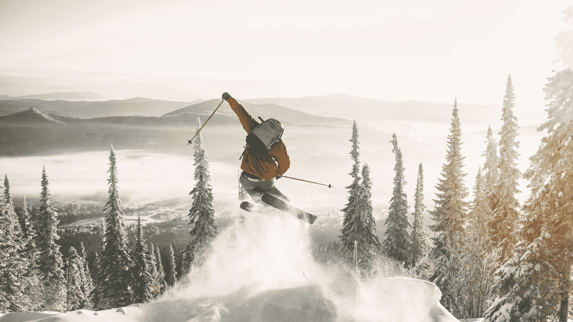 Person intense skiing down hill with kicking up snow through mountain pines