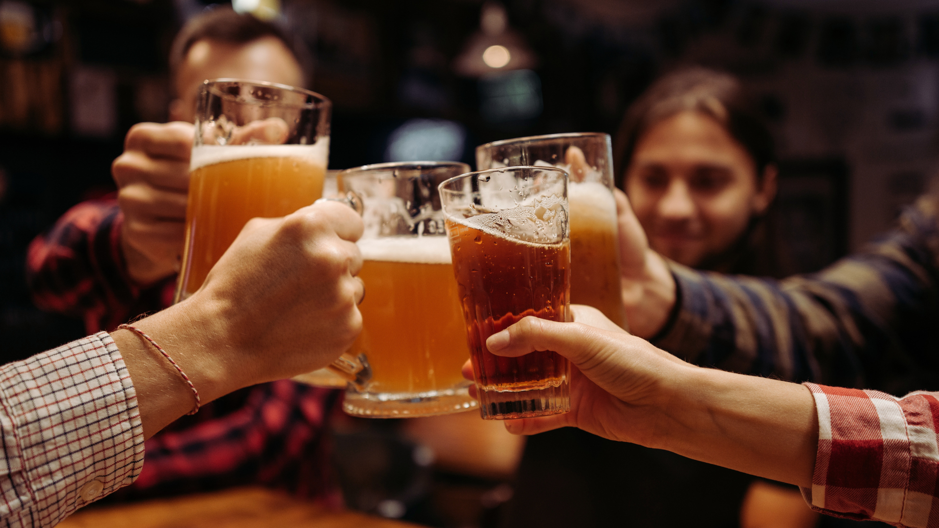 People cheers their glasses of beer together