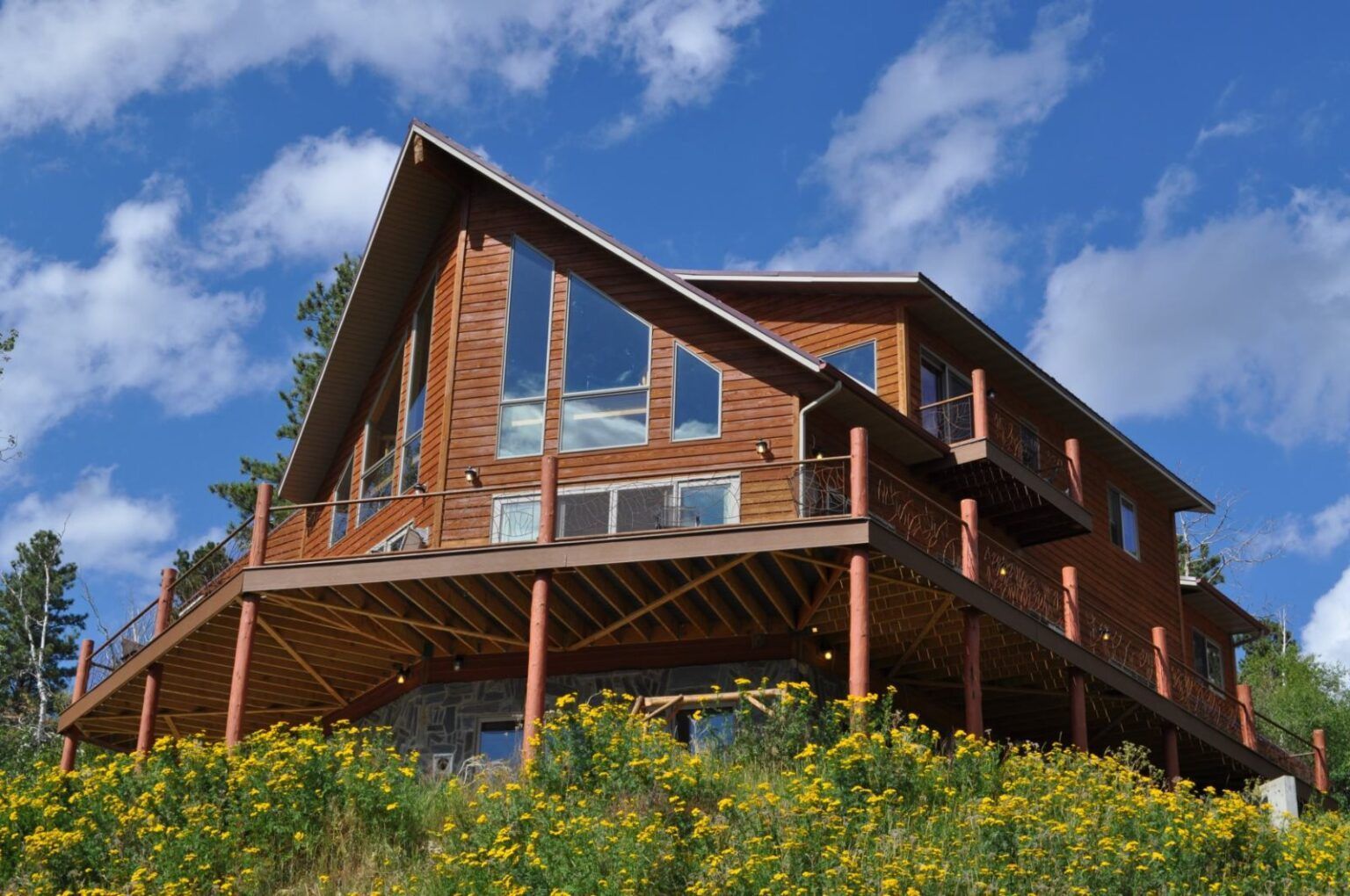Luxury Deadwood Connections cabin rental for large groups on a clear, sunny day