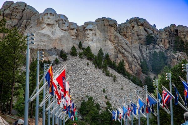 Clear ground view of the historic Mount Rushmore with all country flags located in Black Hills SD