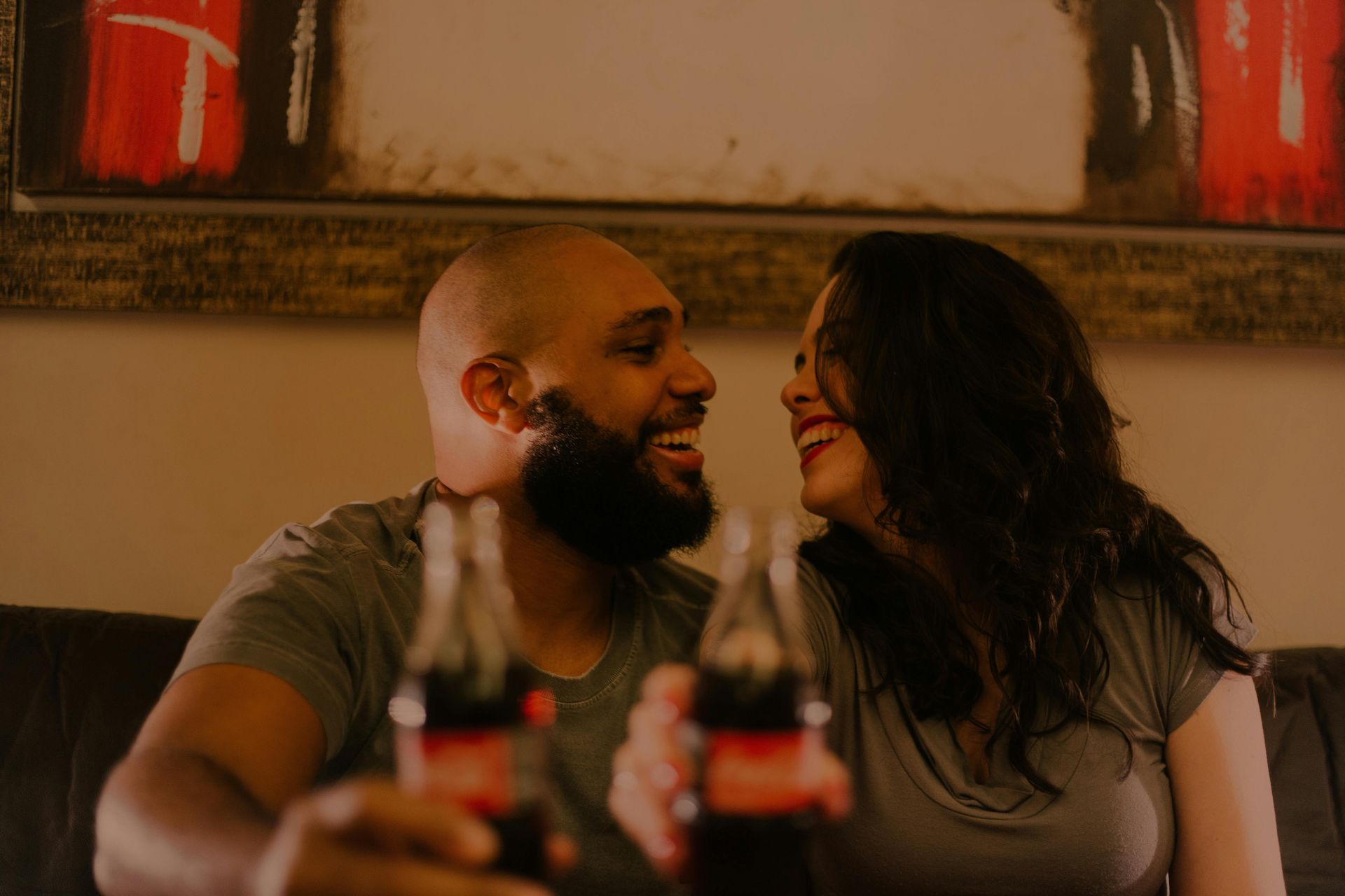 Couple looking at each other enjoying a meal together in a restaurant booth