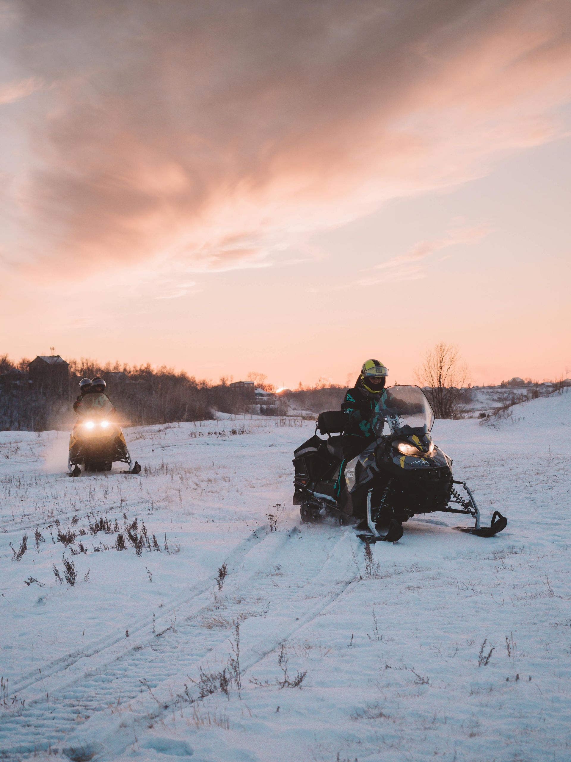 Snocross racers racing across an open winter field