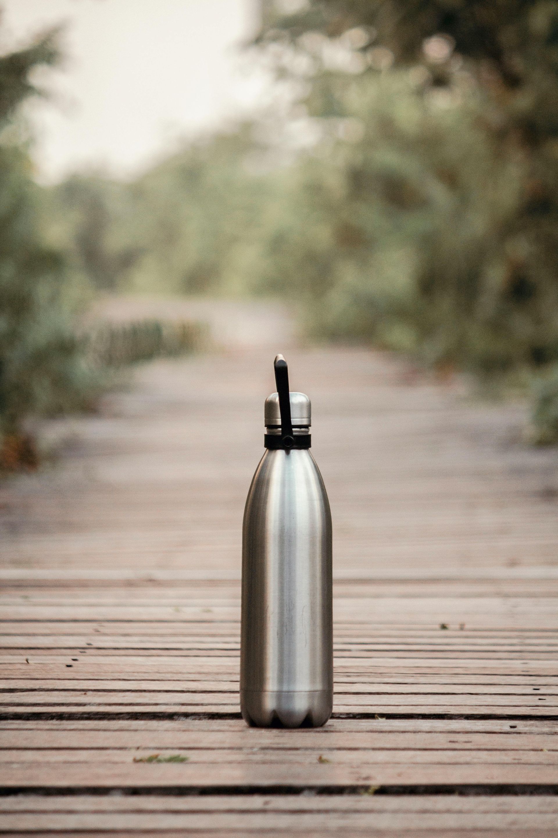 Silver water bottle on a wooden path ready for a day of fishing
