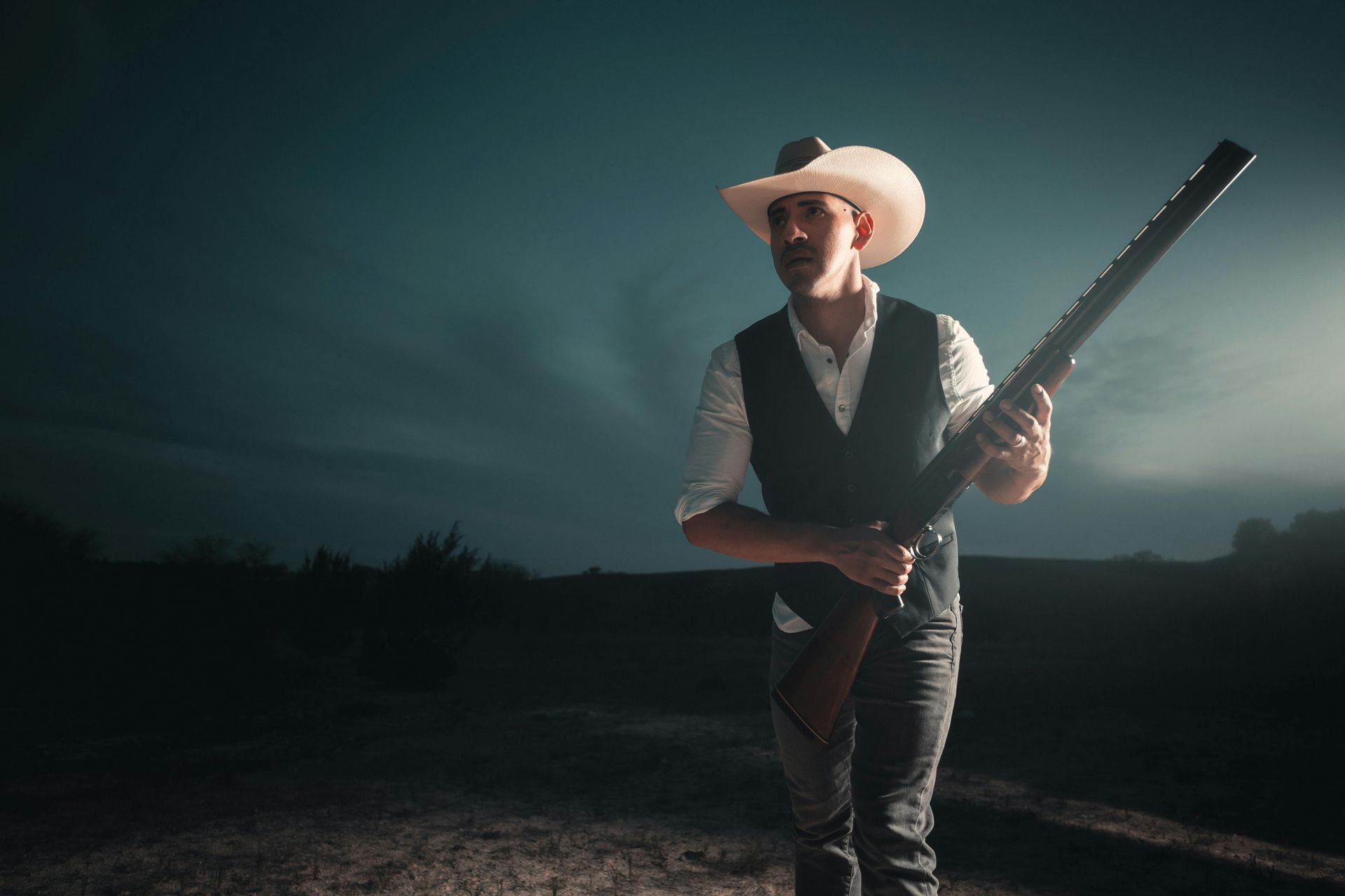Live street performance at night with a man re-enacting a western shootout