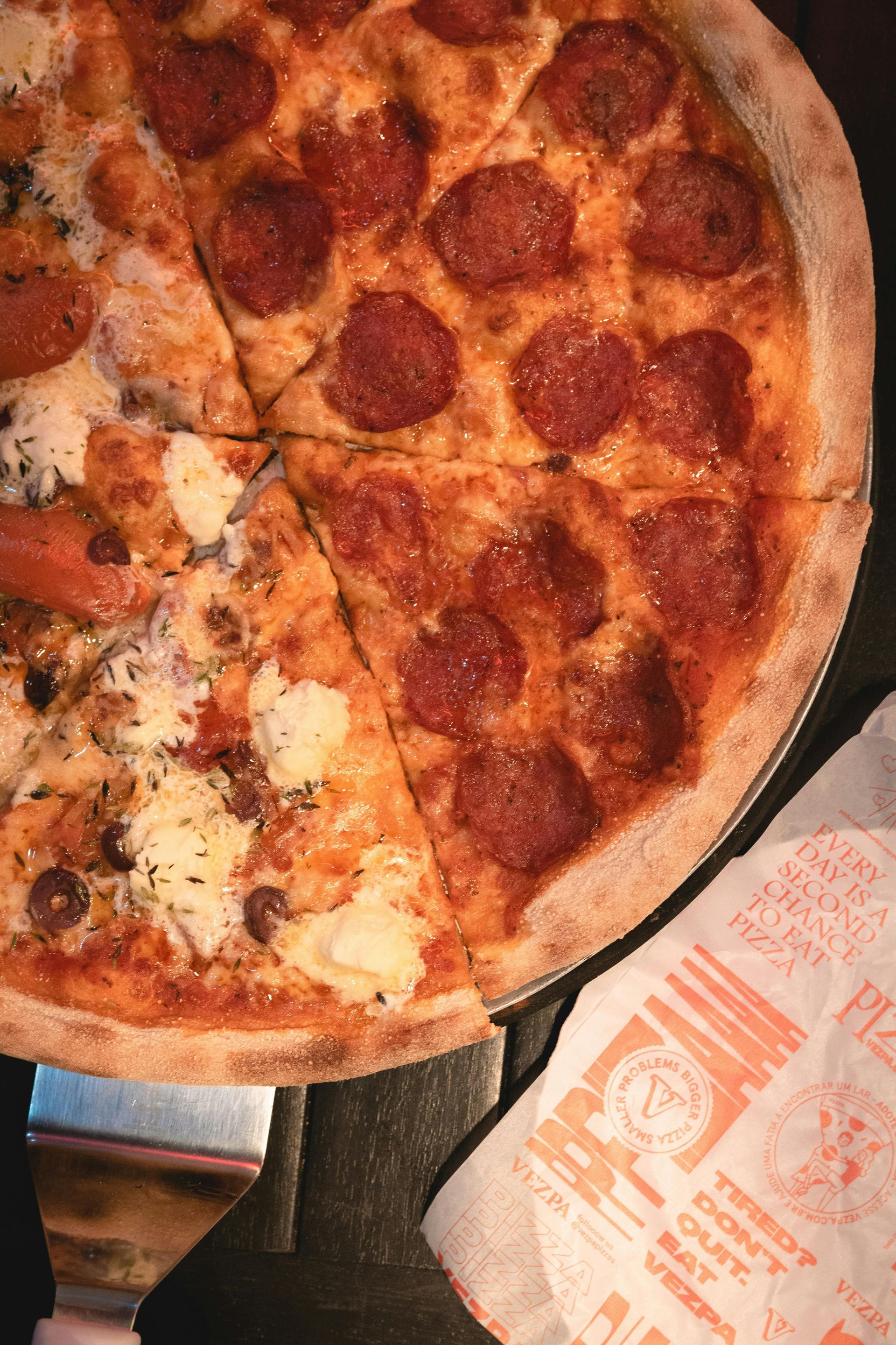 Brick oven cooked pepperoni pizza sliced into large pieces