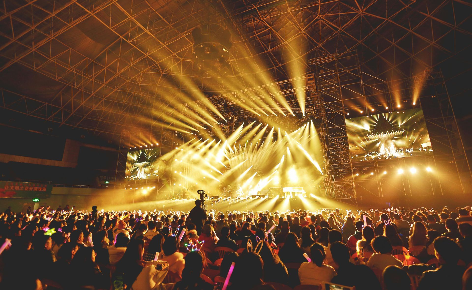 Large group of people enjoying music at an outdoor concert venue
