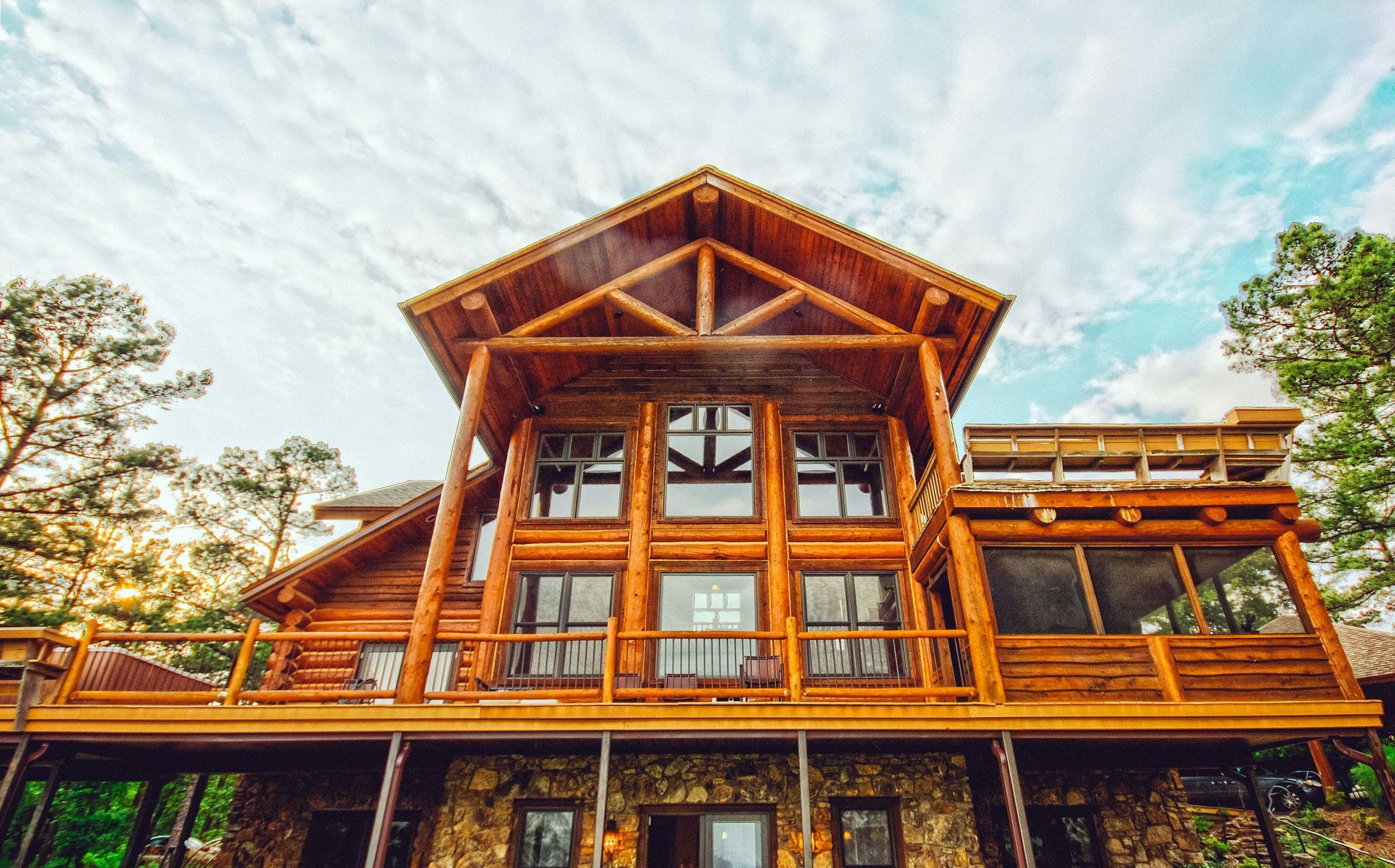 Close up view of a beautiful wood log cabin in the woods with expansive windows