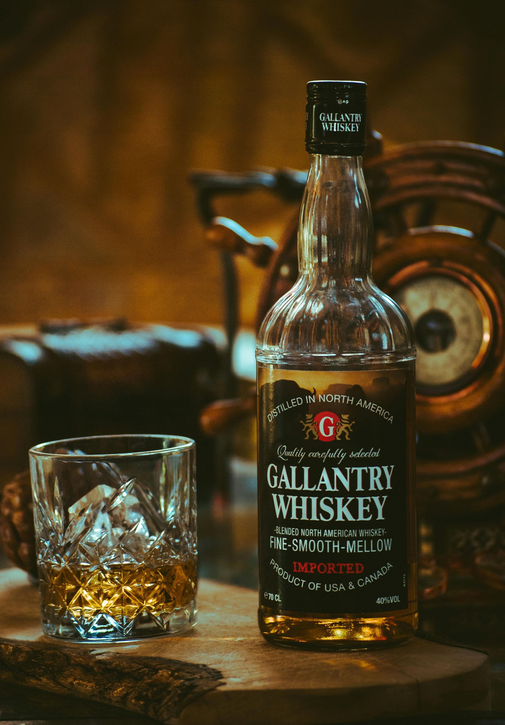 Whiskey bottle standing next to fine glassware with whiskey inside
