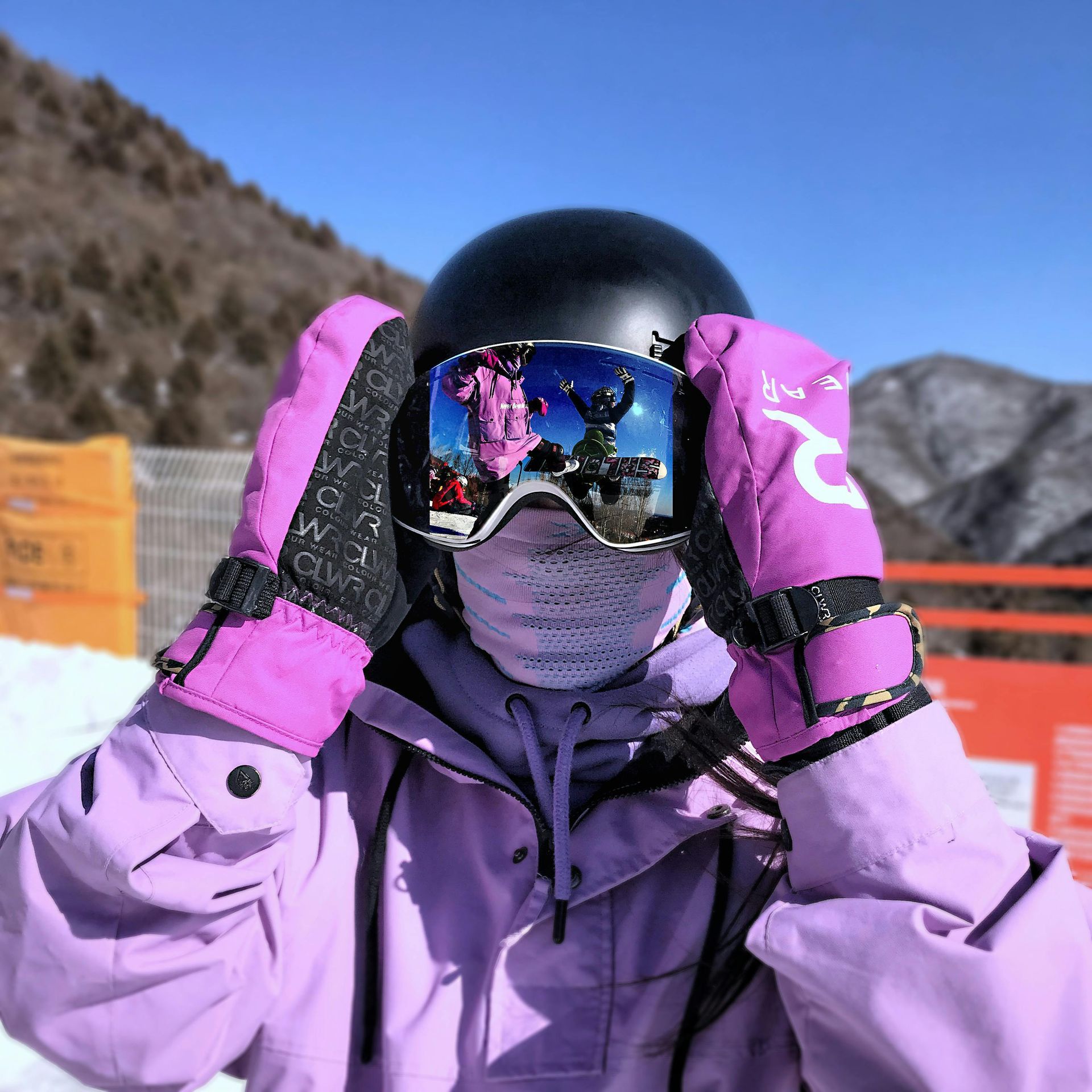 Person wearing a ski helmet on a snowy ski trail