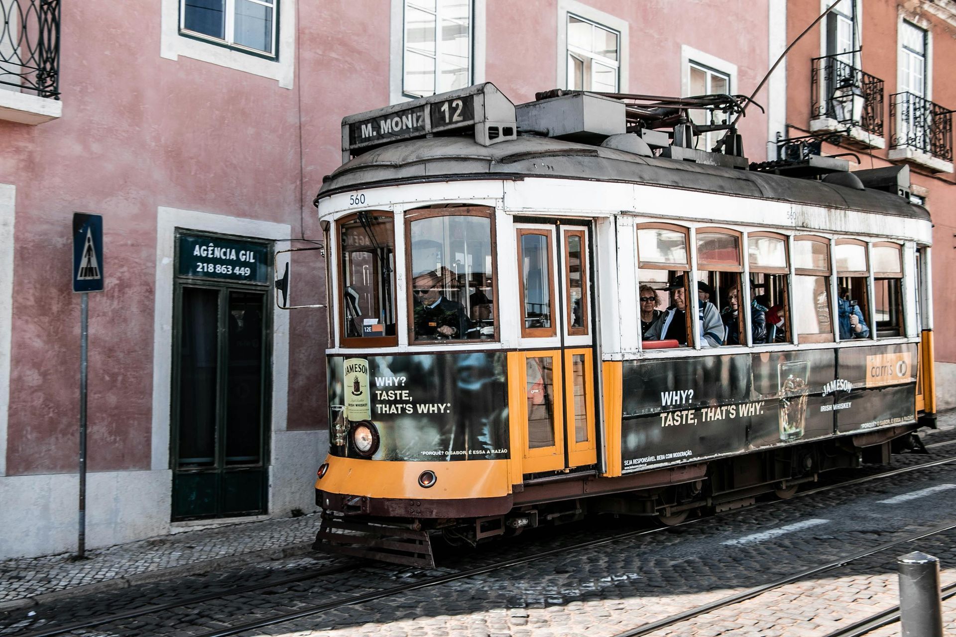 Trolley passing by the local shops and streets of a historic town
