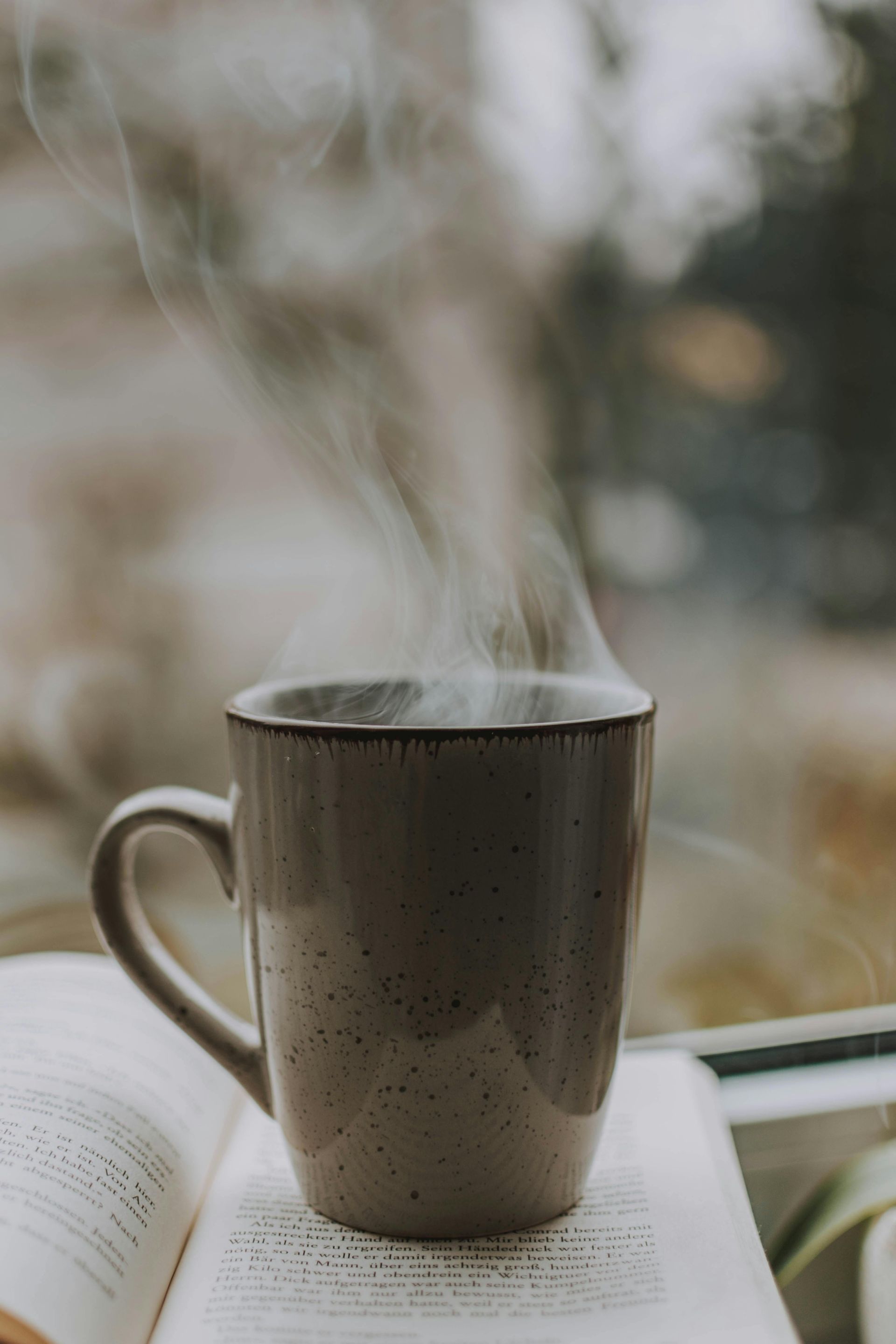 Steaming hot coffee in a glass cup