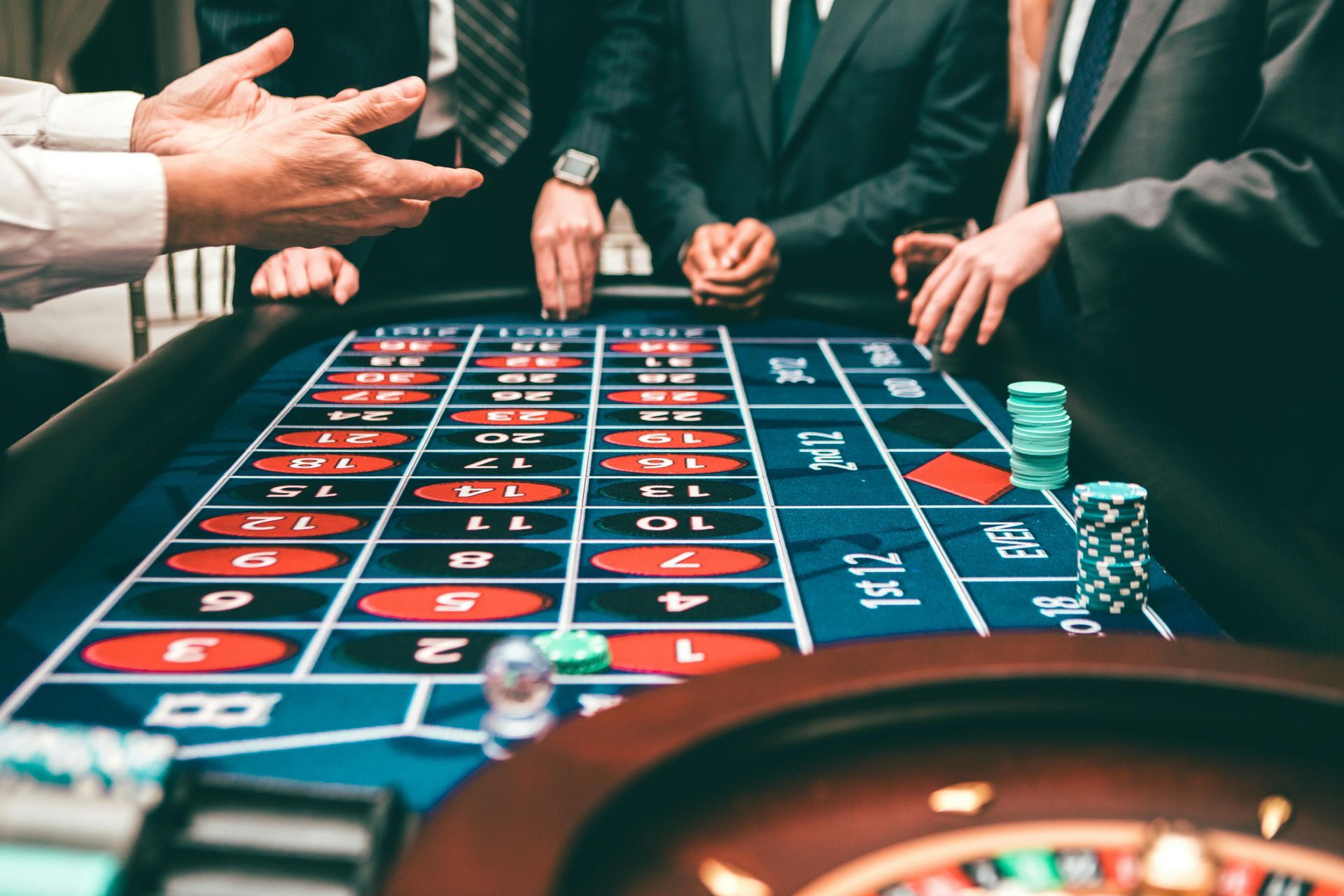 Betting table in casino with people making bets with dice rolling