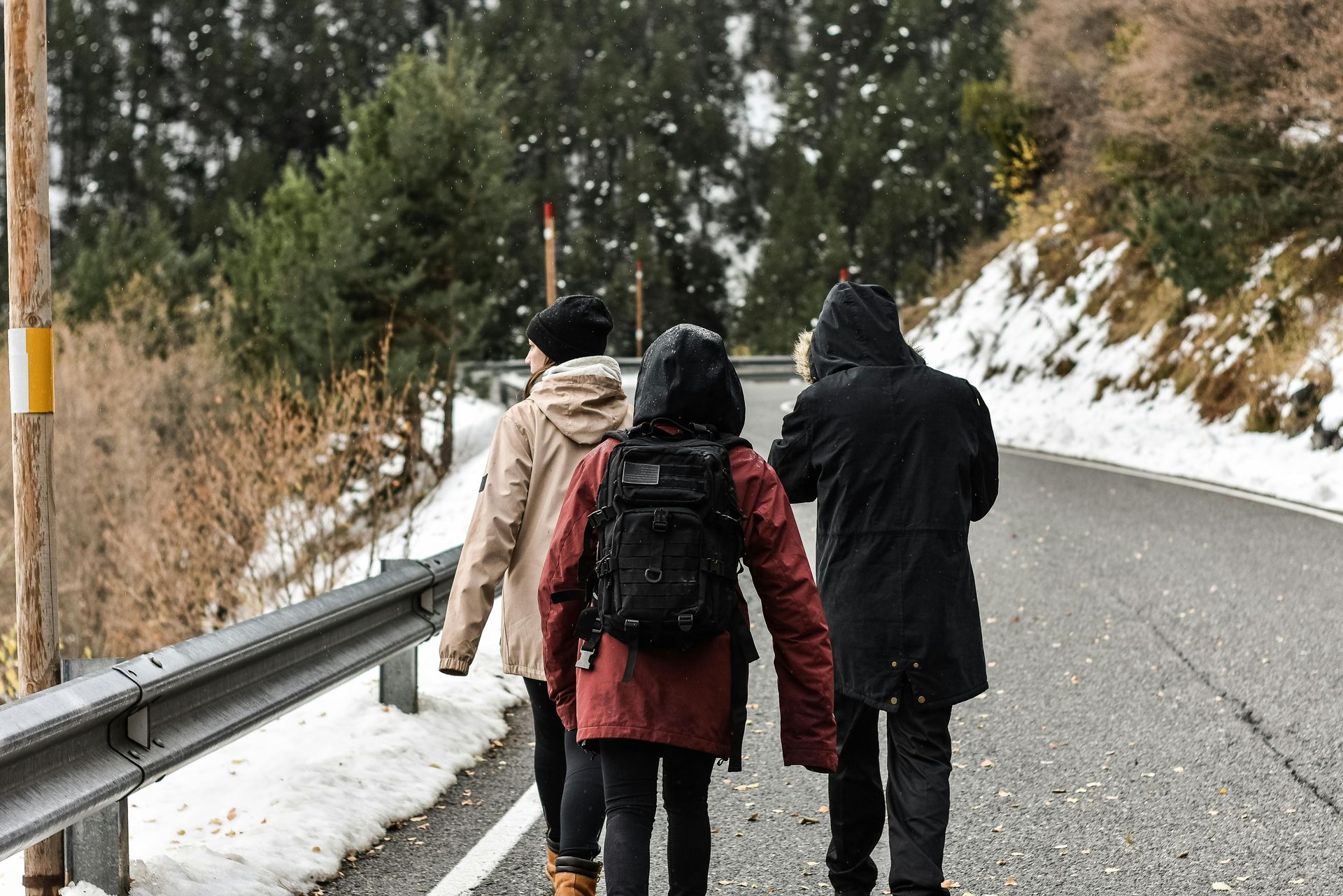People hiking in the snow with proper winter clothing