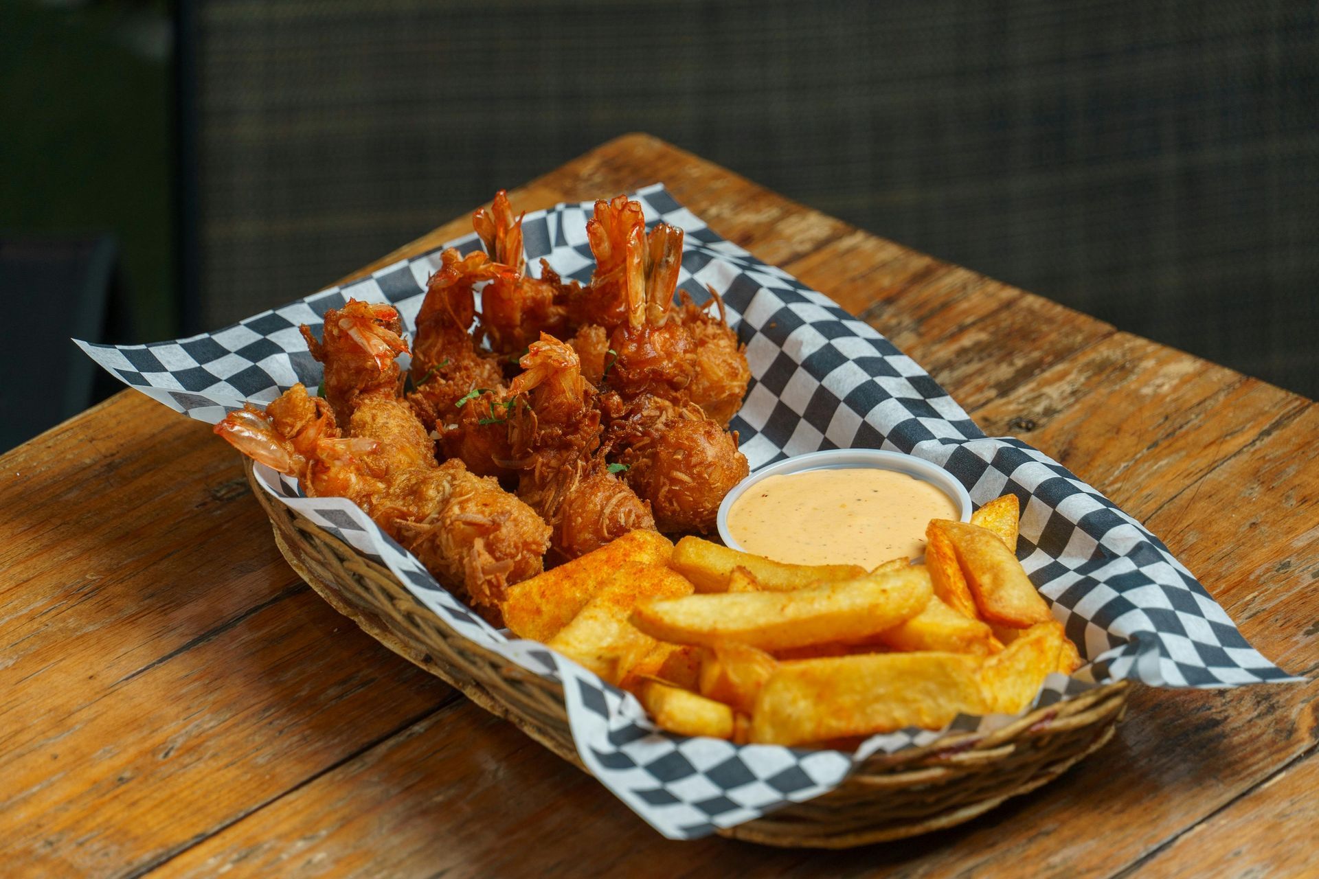 Pub chicken and wings in a basket with fries and dip