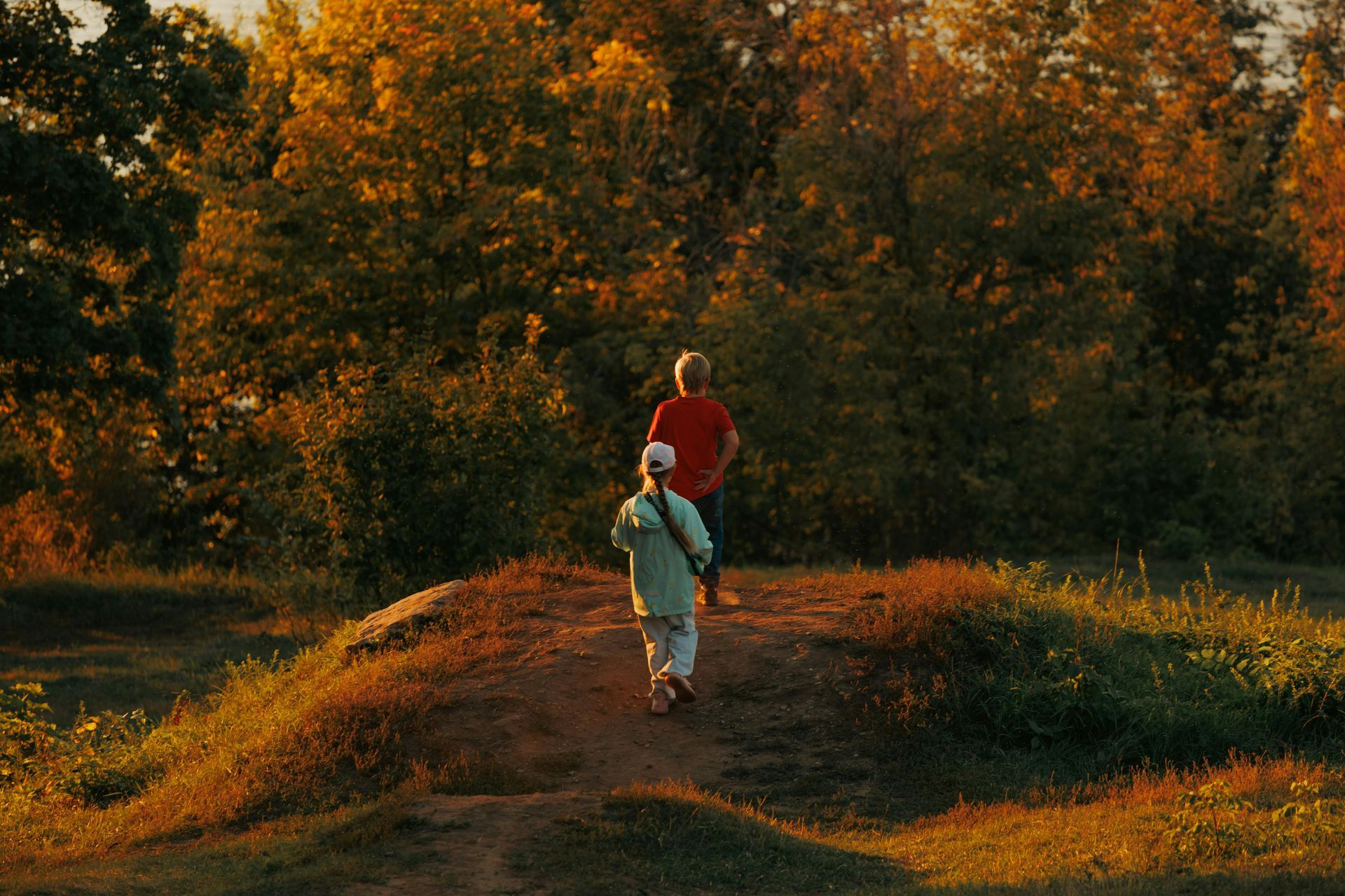 People hiking outdoors during the fall time with changing colors of leaves