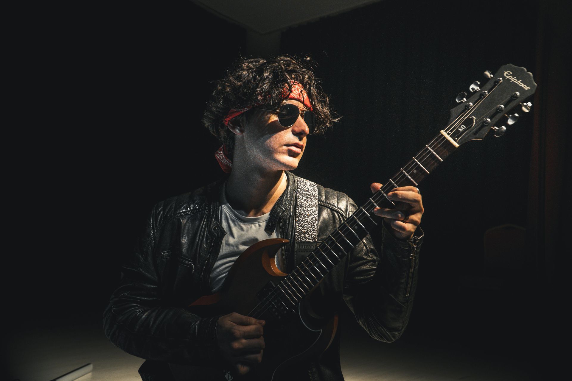 Musician playing a solo act with his guitar during a live music event