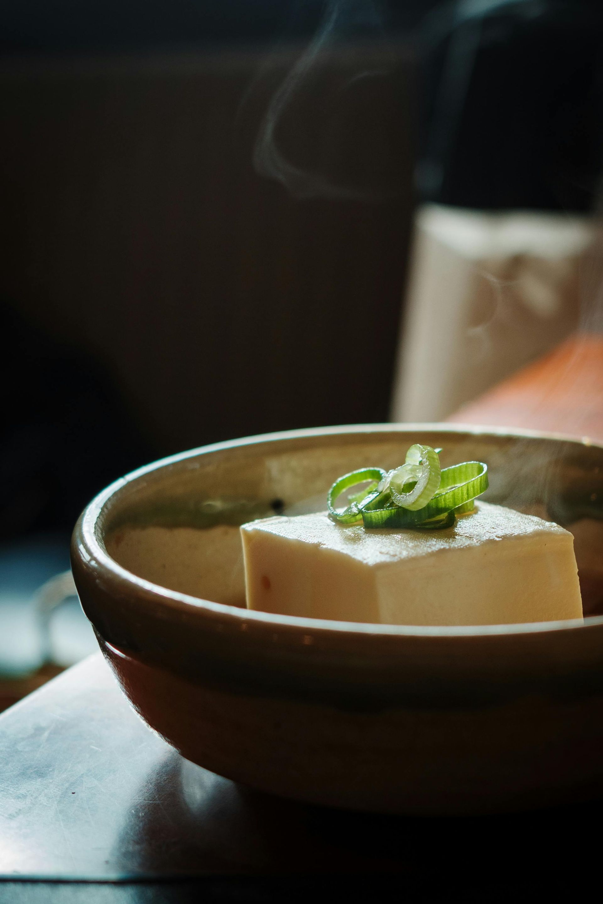 Fine dining food displayed in bowl with garnish on top