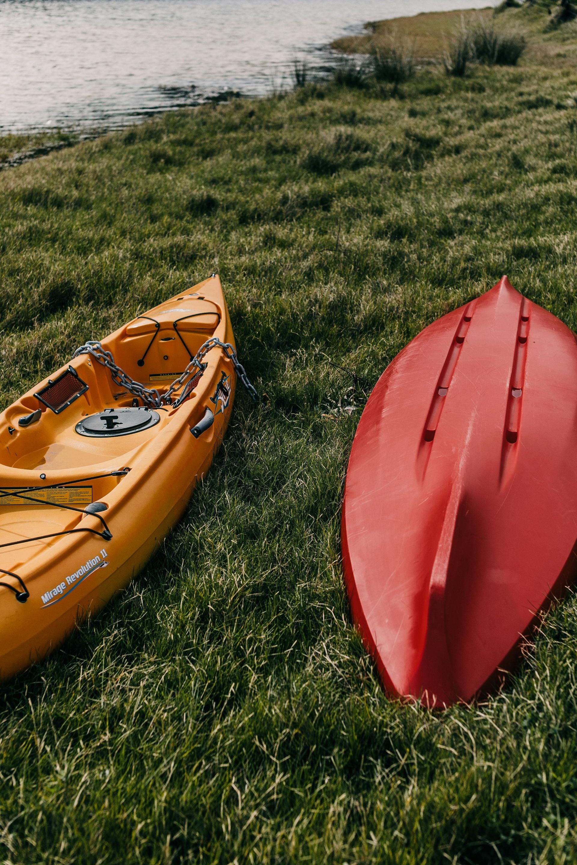 Kayaks sitting on grassy field near water shoreline in the Black Hills