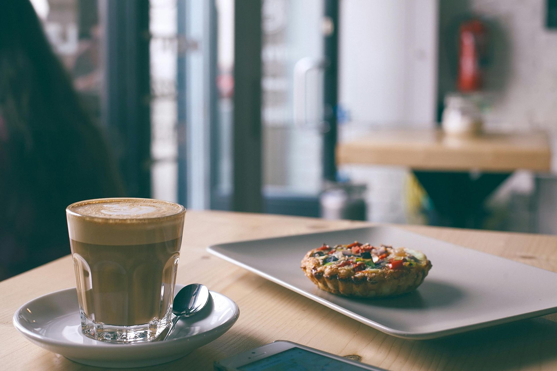 Fresh latte and pastry in a coffee shop
