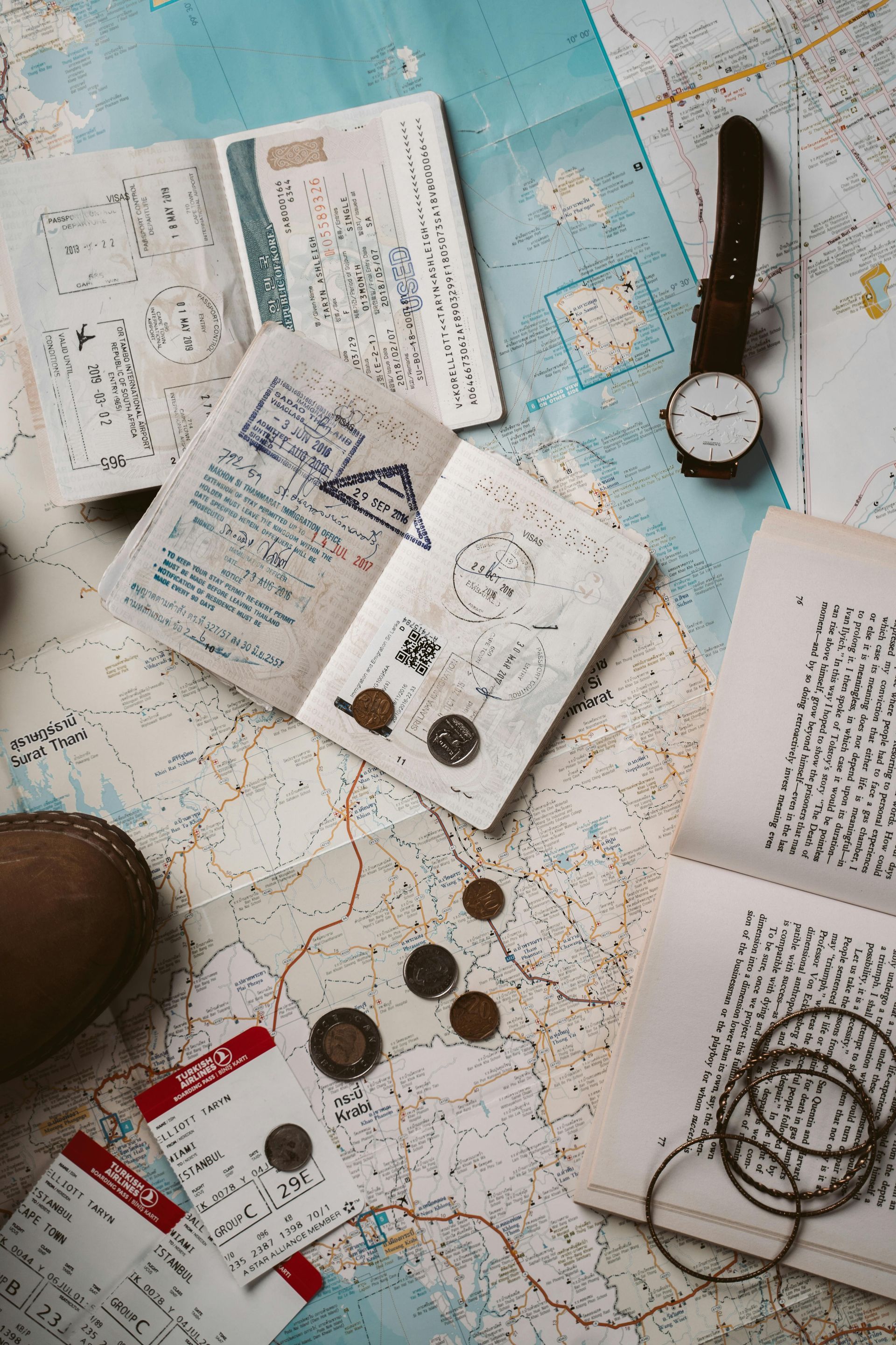 Travel booklet on top of a map and other travel items