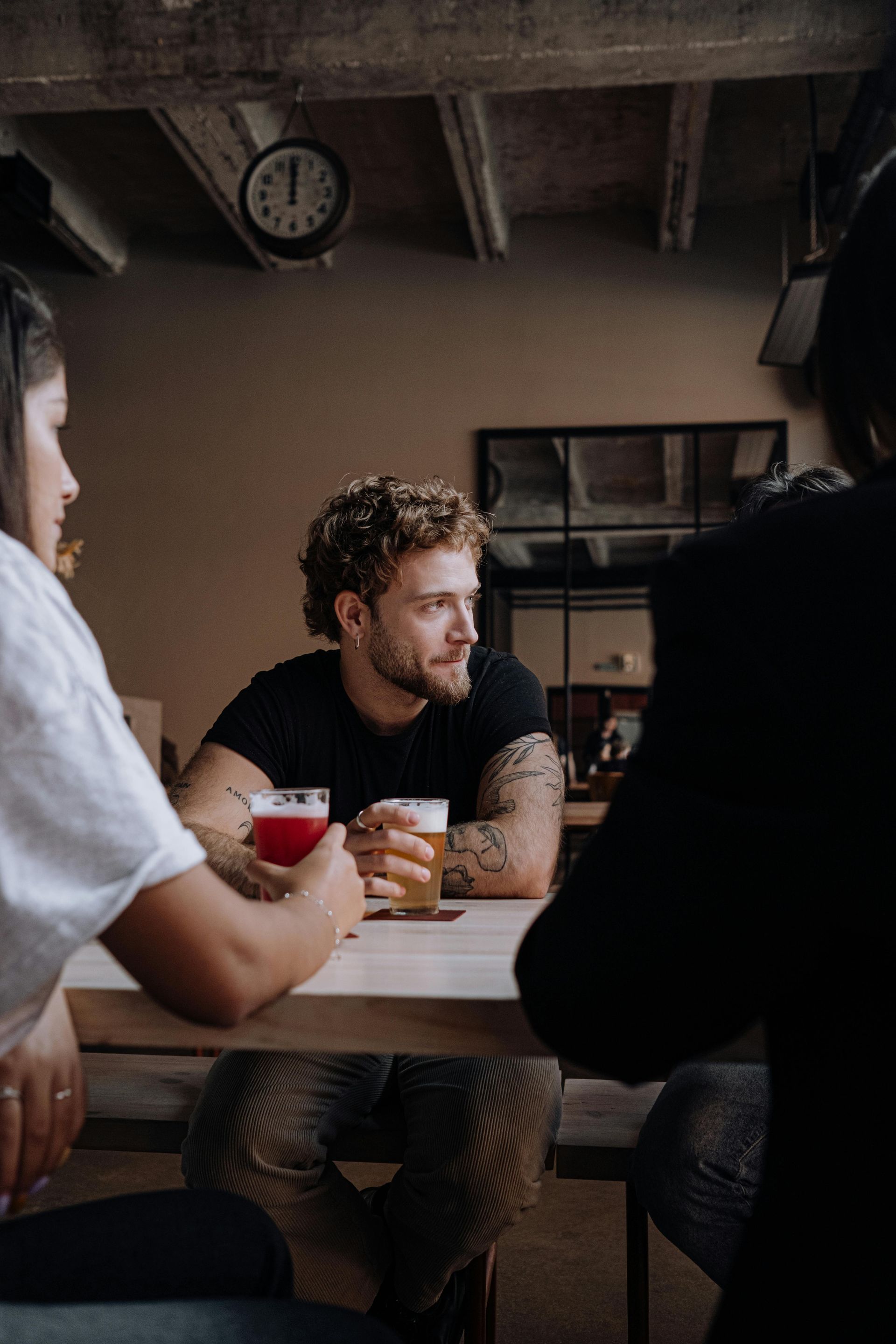 Group of guy friends drinking a variety of beers at a table