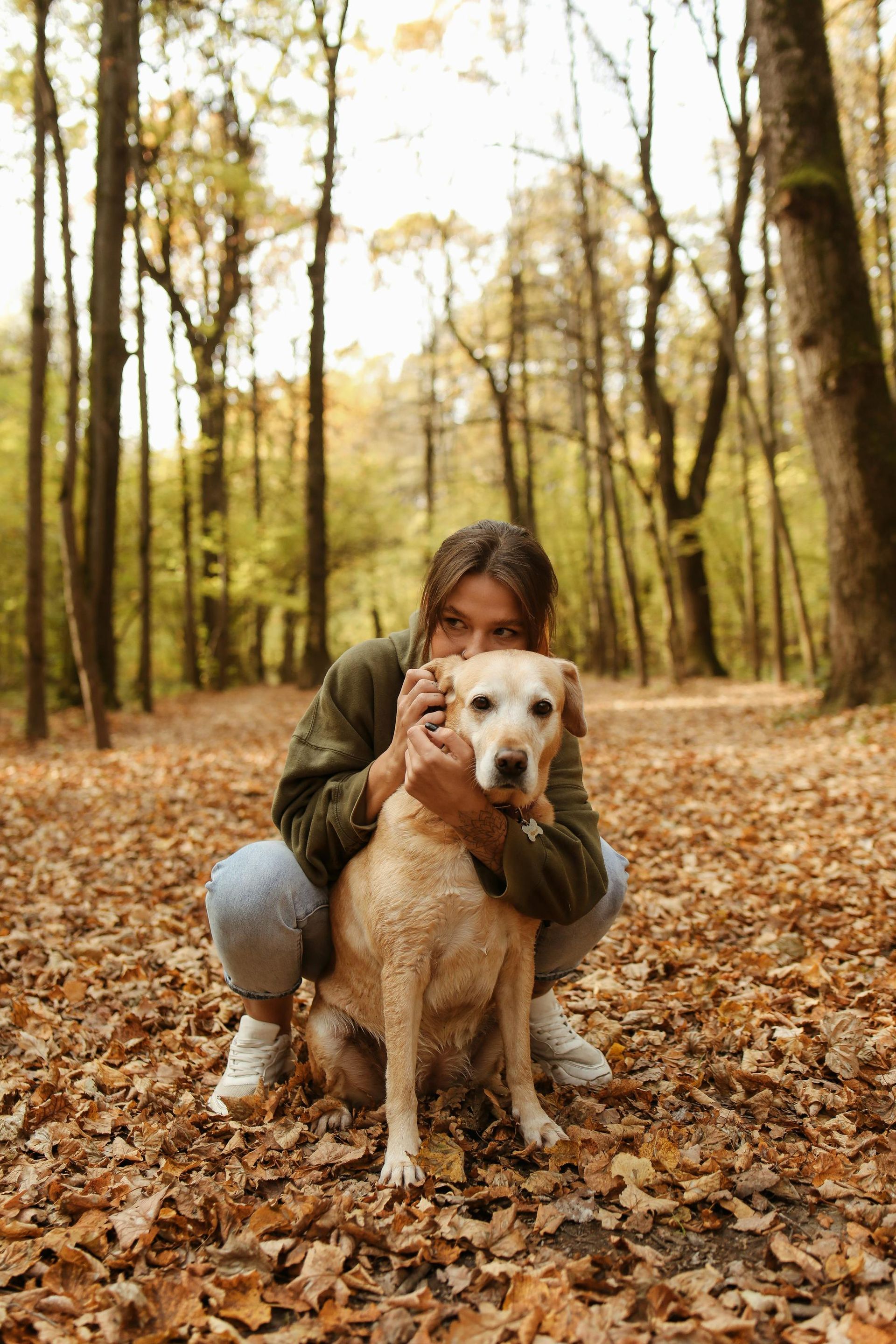 Girl with her dog hiking in the woods together
