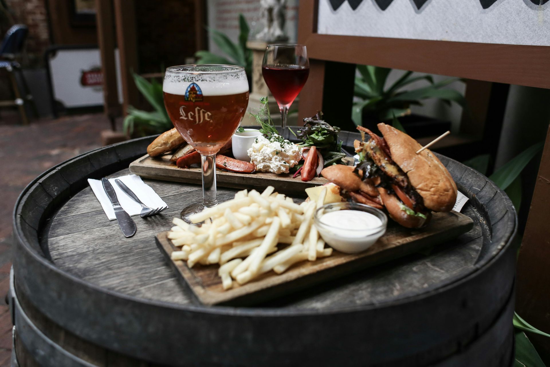 Sandwich with fries on plates with drinks at restaurant 
