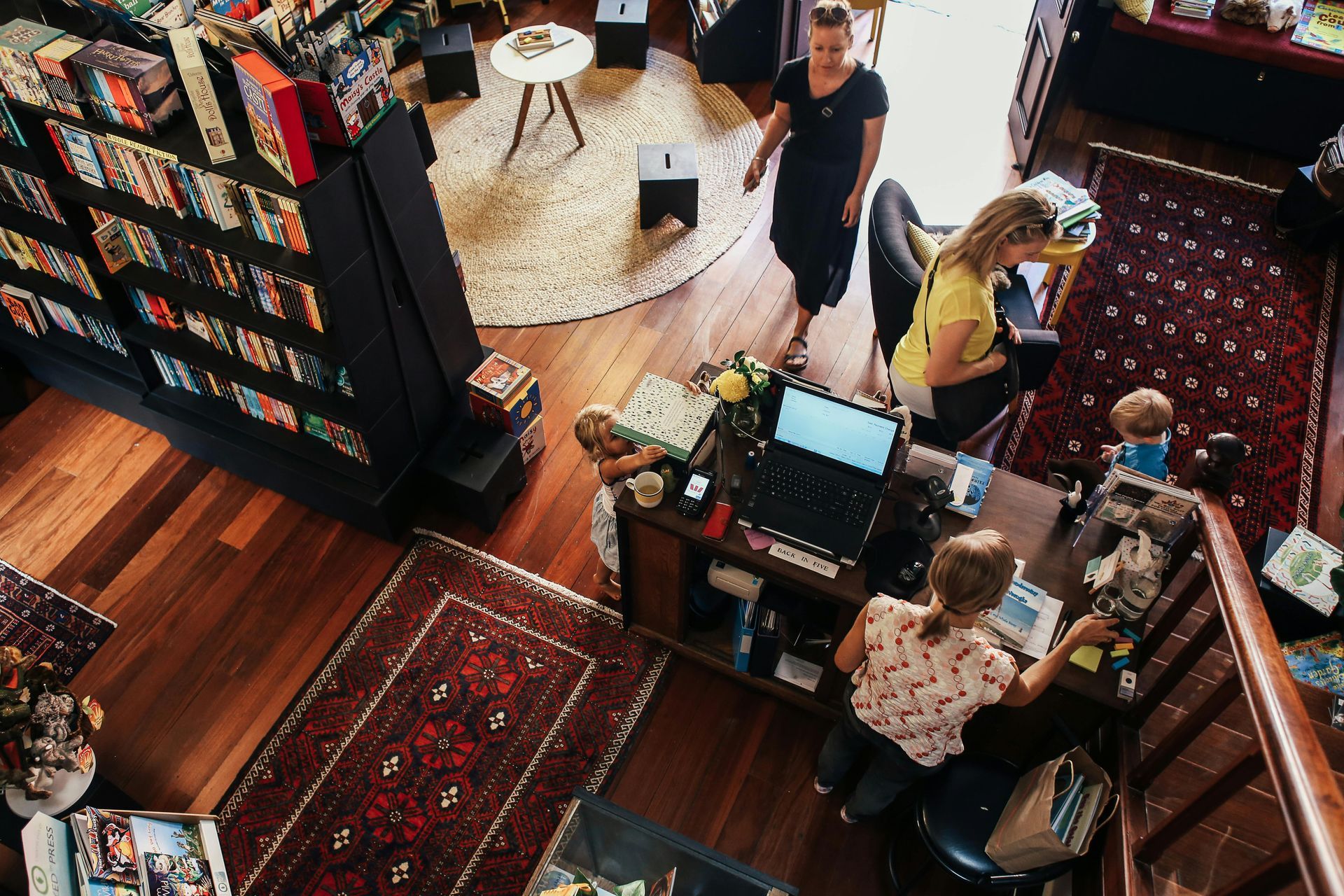 Overhead view of a local shop with customers purchasing local goods