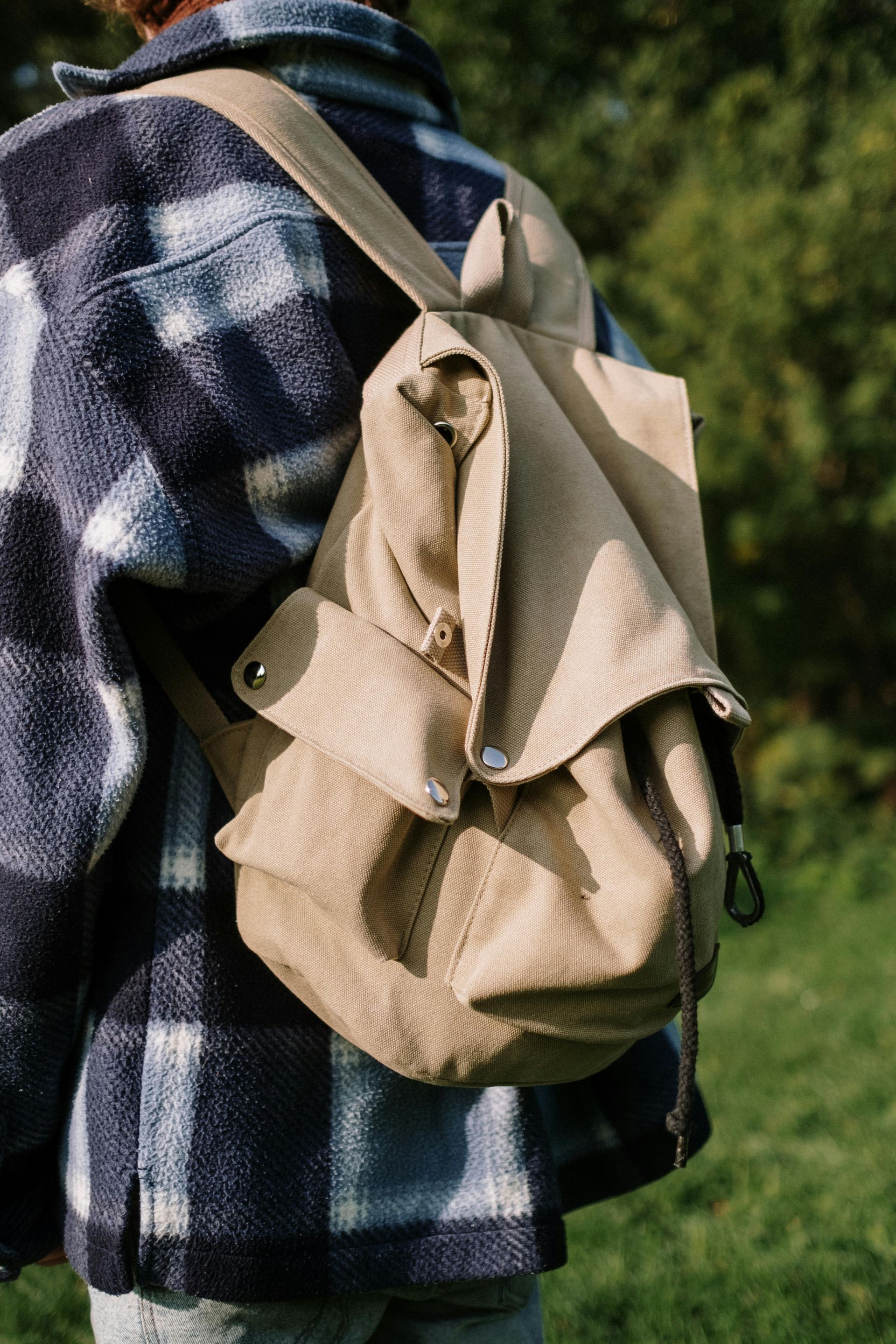 Person carrying hiking bag while enjoying the outdoors