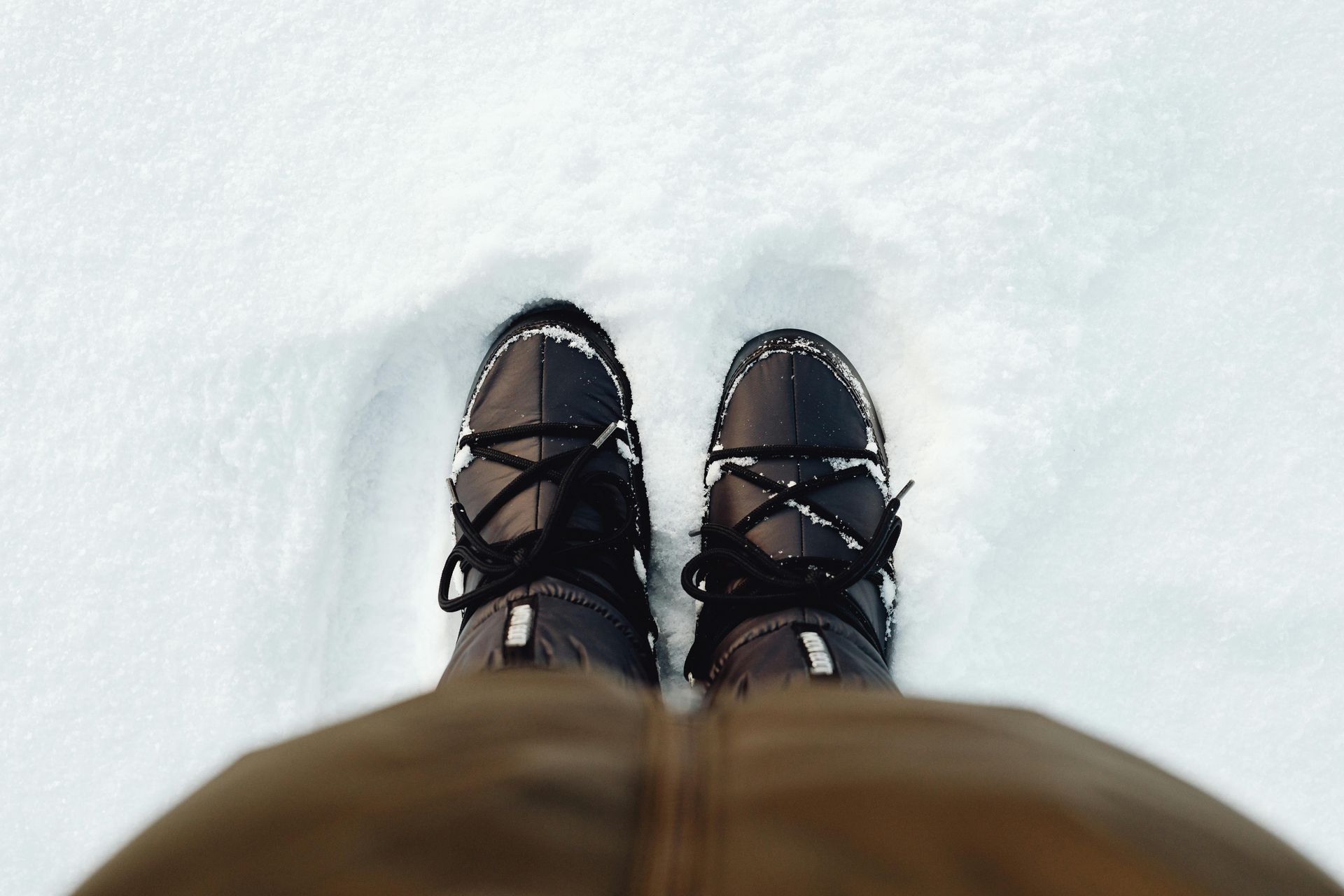 Snow boots in deep white powdery snow