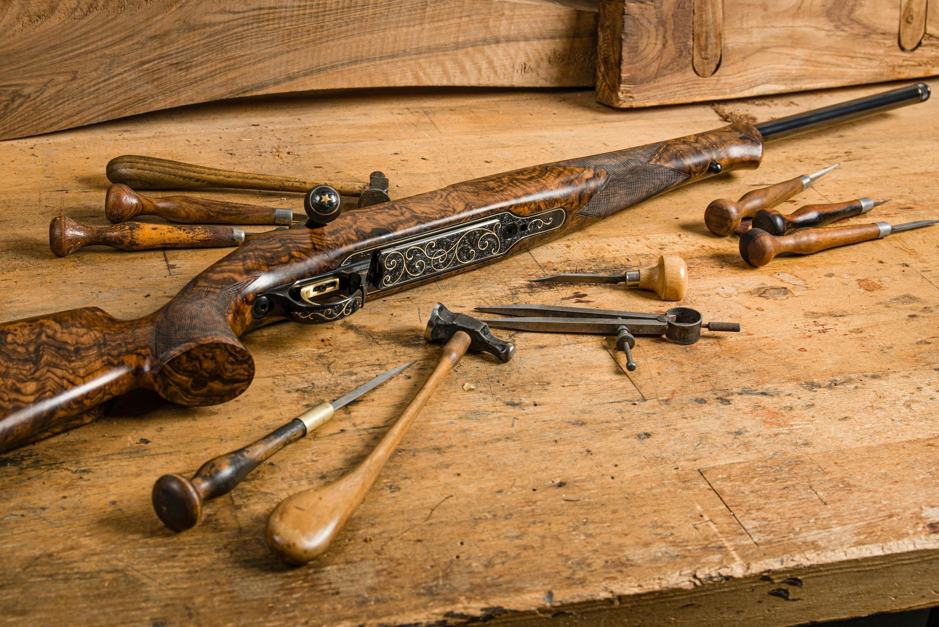 Antique rifle with craftsman tools sitting on table