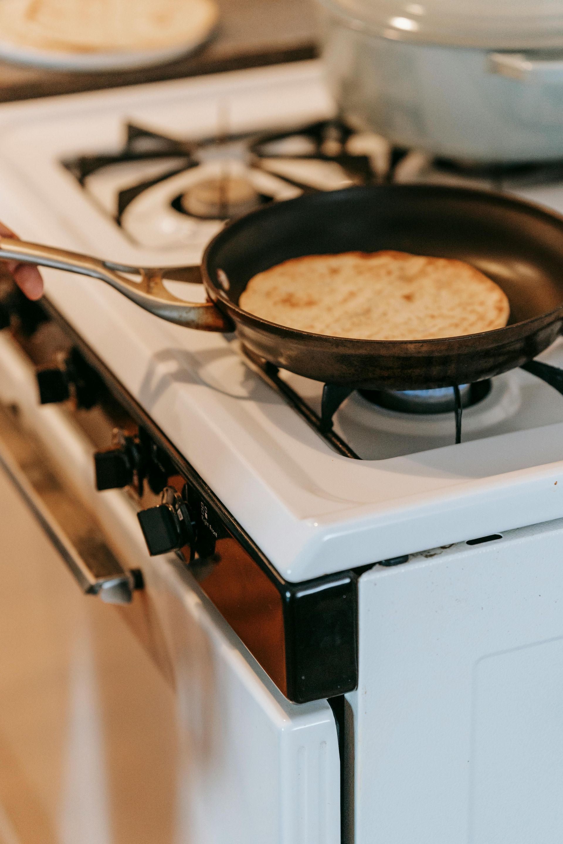 Pan on a stove preparing fry bread to be savored