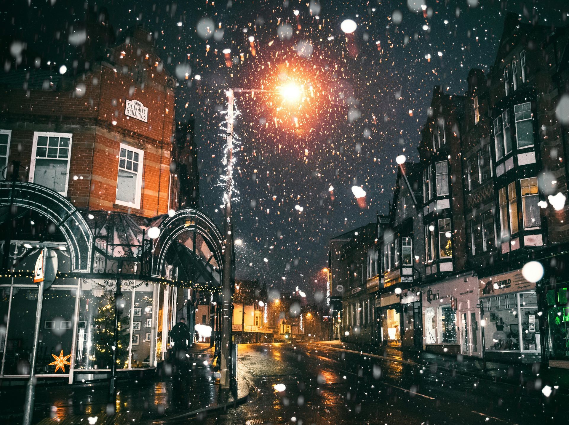Snowy night scene of the shops in a small town